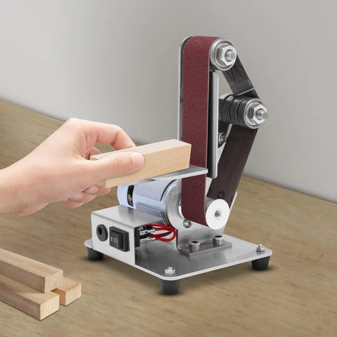 Heavy Duty 110 V Mini Bench Belt Sander Grinder polishing a wood block with adjustable speed and stainless steel build.