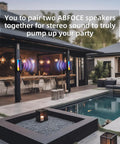 Outdoor setting with two Magnetic Bluetooth Speakers With Solar Charging, 30 Hour Playtime, 7 Colorful LED Lights, mounted on patio walls.
