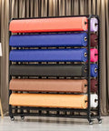 Heavy Duty Adjustable Storage Rack Hella Versatile For Fabric And Vinyl Rolls Featuring Ten Sturdy Rods holding multiple rolls of colored fabric.