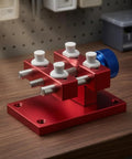 Aluminum Work Holder With Threaded Tightening Screw And Two Sliding Clamps Rock Solid Red Anodized Finish Heavy Duty Workshop Tool For Precise Part Holding And Repair on bench