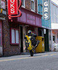 Rider performing a wheelie on a Heavy Duty Electric Dirt Bike Two Pack Crafted For Teens And Adults Packing 5500W Badass Motors With 276Nm Killer Torque Blasting To 55 Mph Plus A Dope Helmet Included For Off Road Adventures.