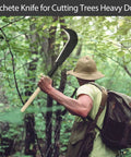 Man using Beefy Heavy Duty Steel Machete With Wooden Handle For Clearing Brush And Small Trees in forest