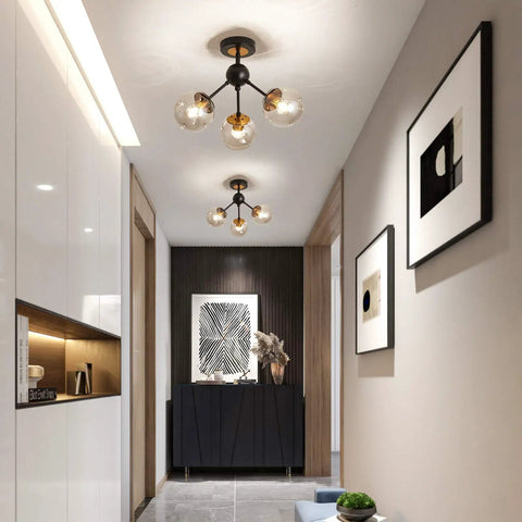 3 Light Vintage Semi Flush Mount Glass Globe Chandelier In Black Finish in a modern hallway setting.