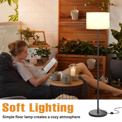 Side view of floor lamp: black metal pole, white shade, 60-inch tall, foot pedal switch