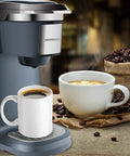 One Touch Single Cup Coffee Brewer With Quick Brew, 12 Oz Grey Coffee Maker, steaming cups next to machine