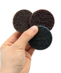 Grab These 50 Pieces Of Awesome 2 Inch Nylon Sanding Discs With 1/4 Inch Holder For Orbital Sanders To Smooth Wood, Metal And Walls Like A Boss; hand holding three round sanding discs.