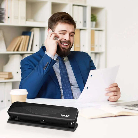 Businessman using Low-Force No-Fuss 3-Hole Punch for 20-Sheet Capacity, heavy-duty desktop paper punch with squeeze handle, in office setting