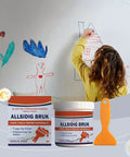Child drawing on wall with crack repair paste and scraper tools in foreground for fixing plaster and drywall cracks.