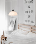 1 Light Plug-In Pendant Light In Dark Bronze With Frosted Shade And Adjustable Clear Cord Height above a bedroom bed