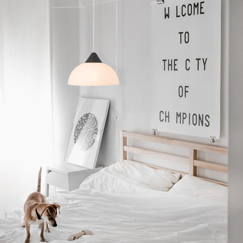 1 Light Plug-In Pendant Light In Dark Bronze With Frosted Shade And Adjustable Clear Cord Height above a bedroom bed
