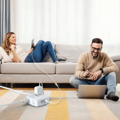 Couple using 10 Foot Surge Protector Power Strip With 8 Wide AC Outlets And 4 USB Ports 3-Side Extender for devices in living room