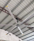 287 Inch Industrial Ceiling Fan Heavy Duty Workhorse With 6 Aluminum Blades Permanent Magnet Direct Drive Motor Variable Speed mounted in a large industrial space.