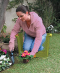 Woman using Garden Kneeler And Seat With Storage Compartments, Heavy Duty 255 Lbs Capacity, Cushioned Knee Pad outdoors
