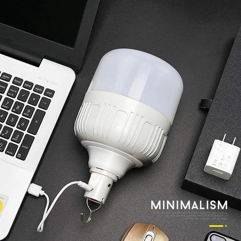 Newest 30W 5500LM Waterproof Rechargeable LED Night Light Bulb with hanging hook on a desk.