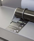 Close-up of All-In-One Coil Punch, Electric Inserter and Electric Coil Crimper with oval holes, showing sheet capacity guide.