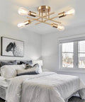 Six Light Sputnik Ceiling Chandelier Dope Modern Semi Flush Mount With E26 Base Brass Finish in bedroom setting.