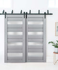 Veregio 7455 Interior Barn Bypass Sliding Doors With Frosted Glass 84x80 in black modern style installed in a bright room.