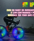 Cyclist riding in rain with Three Pronged Bicycle Spoke Lights Set for Bike Wheels With 360 Degree Visibility LED Wheel Lights