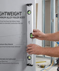 LYIYEYAN 24-Inch Magnetic Torpedo Spirit Level, Heavy Duty Ruler for Carpen held against a wall, displaying bubble levels, aluminum alloy.