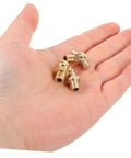 Hand holding fittings from 9 Piece Copper Grease Fitting Kit For Cars And Trailers, Pro Grade Nozzles And Oil Caps, Straight And Angled Nipples