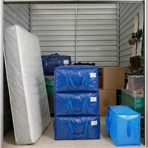 Extra Large Moving Bags 2 Pack Heavy Duty With Zippers And Carrying Handles stacked in storage unit with other items.