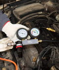 YSTOOL cylinder leak-down tester with dual gauges and extension rod connected to car engine bay
