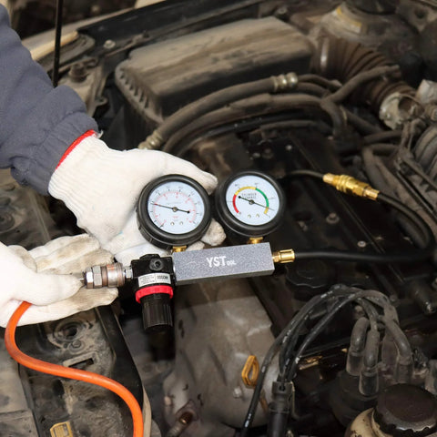 YSTOOL cylinder leak-down tester with dual gauges and extension rod connected to car engine bay