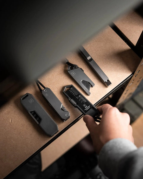 Hand picking up Titanium EDC Wrench For Everyday Carry With One Handed Operation Removable Pocket Clip Paracord Lanyard And Key Ring Universal 25 Size SAE And Metric Wrench Set In Silver from shelf