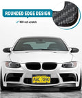 Front view of a car with Real Carbon Fiber License Plate Frame Hand Wrapped With Stainless Steel Holder highlighting rounded edge design.