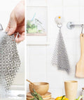 8x6 Inch Cast Iron Chainmail Scrubber hanging and being washed, stainless steel, for safe scratch free cleaning of pots and pans