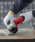 Premium Heavy Duty 4 1/2 Inch Angle Grinder With A Badass 7.5 Amp Motor cutting through metal surface with precision.