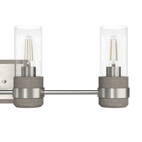 Close-up of the Four Light Vanity Light in Brushed Nickel Sleek Rustic Style Dimmable Fixture with clear seeded glass shades.