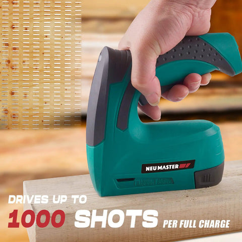 Cordless 2 In 1 Brad Nailer And Stapler Kit With USB Charger Cable in hand, showing use for carpentry on wood surface.