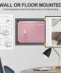 Wall-mounted pink home safe box for kids and money, compact lock box with key shown next to a desk lamp and chair.