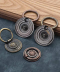 Vintage Oil Rubbed Bronze Ring Pulls for Cabinets and Drawers, 2 Inch Diameter, floral pattern variety laid on dark blue fabric