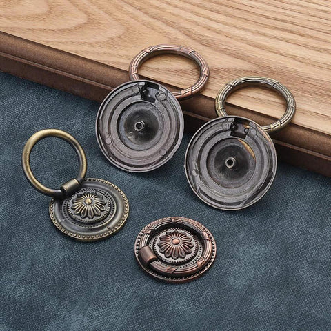 Vintage Oil Rubbed Bronze Ring Pulls for Cabinets and Drawers, 2 Inch Diameter, floral pattern variety laid on dark blue fabric