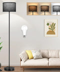 Minimalist Floor Lamp With White Linen Fabric Shade, Tall Modern Standing Light For Living Room Bedroom Or Office, Black Metal Pole And Base With Foot Switch, E26 Base, No Bulb Included in living room setting with wall art and plants.