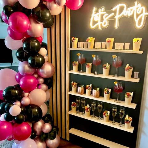 Hot Pink And Black Balloons Set 60 Count With Confetti, 12 Inch Latex Party Decorations arranged beside a party drinks display