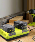 Dual Chemistry 18V Ryobi Battery Charger With Dual Ports Charges Two Batteries At Once For P117 P118 P119 P190 P102 P103 P107 P108 PBP Series For Ryobi One Plus Batteries LiIon NiCad NiMh on workbench with tools