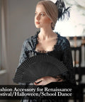 Woman holding Black Hand Fan For Stage And Rave Dancers With Elaborate Design And Satisfying Snap Clack Go To Handheld Fan For Line Dancers 13 Inch Closed Size For A Bold Onstage Statement, dressed in black lace attire, feathered hat.