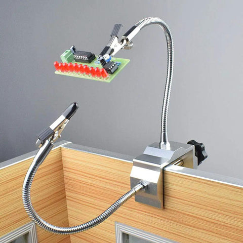 Soldering Third Hand Tool with tabletop clamp, flexible nickel plated arms, rotatable alligator clips holding circuit board.