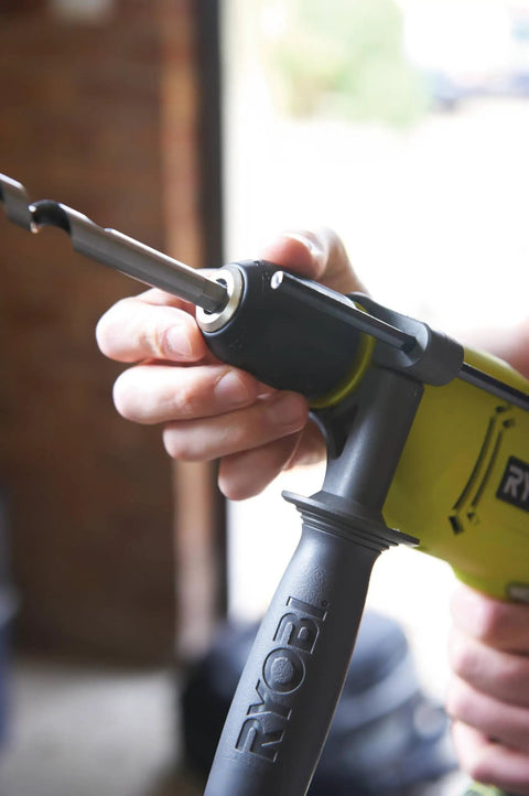 Close-up of a hand operating the quick release chuck of the Compact Hammer Drill With Variable Speed Trigger And Reversal Built.