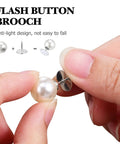 Close-up of a hand holding a pearl cleavage cover safety pin with a metal backing, demonstrating use for garment styling.