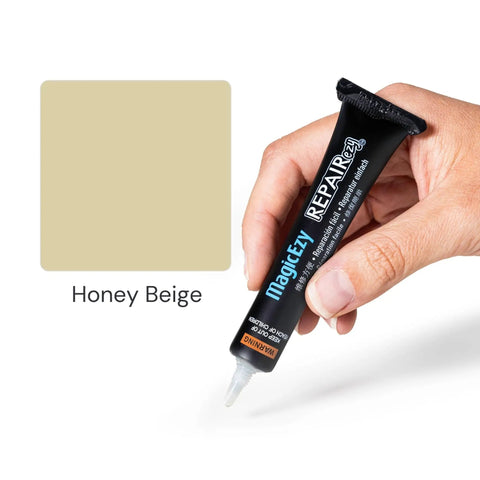 Hand holding Honey Beige Ceramic Tile Repair Kit with nanotech filler for cracked bathroom tiles.