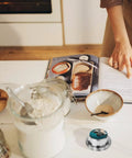 Go To Ocean Penguin Stainless Steel Timer With Magnetic Base on kitchen counter near baking ingredients and cookbook