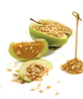 Caramel apple slices topped with chopped nuts using No Fuss Nut And Topping Chopper For Quick Snack Prep And Ice Cream Toppings