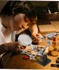 Person using Adjustable Third Hand Soldering Station With Magnifying Glass And Dual Alligator Clips For PCB Repair