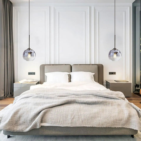 Bedroom with two Modern Black Globe Pendant Lights With Mercury Glass Shade, enhancing the minimalist decor above a bed.