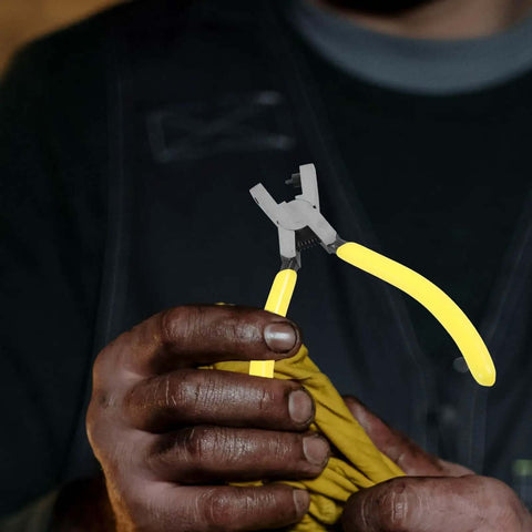 Man using Heavy Duty One Hole Puncher Plier For DIY And Office Use 2mm Metal Paper Punch Tool with yellow handles