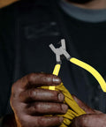 Person holding Handheld Single Hole Puncher Plier for Office and Craft Projects Do It All Tool with yellow handles